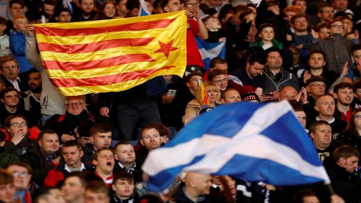 Football fans fly flags in support of Scottish and Catalonian independence